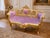 This striking late 20th-century French Louis XVI–style settee combines sculptural carved woodwork with sumptuous rose-pink...
