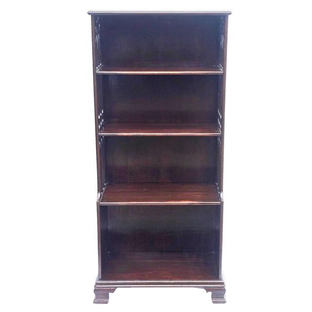 A charming narrow vintage mahogany Chippendale‑style bookcase dating to the 1940s, designed with a compact footprint ideal...