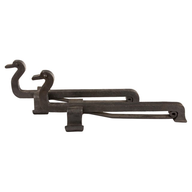 A charming and meticulously crafted pair of French duck-shaped andirons, showcasing exceptional metalworking skill. Likely...