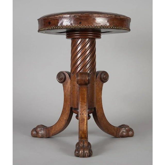 Regency mahogany adjustable revolving piano stool on tripod base with spiral carved pedestal terminating in carved finial,...