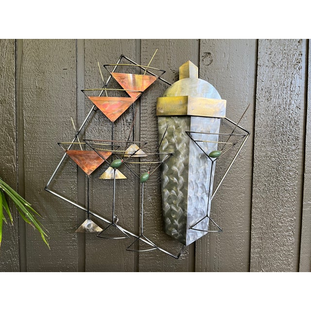 A spirited and sophisticated vintage wall sculpture titled 'Manhattans & Martinis,' attributed to the iconic studio of...