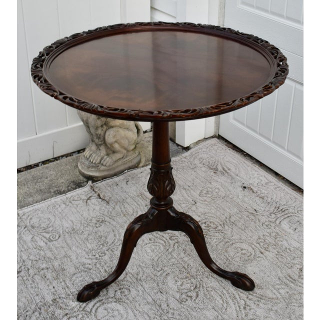 Vintage (1940's) Tilt Top Table has a Chipendale Style. The Wood is Mahogany. The table has a Flame Grain Top with a...