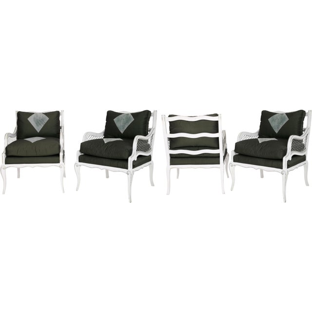 Set of four Maison Jansen armchairs with ladder back and metal accent arms. Loose bottom and back cushion of Henry Calvin...