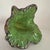 The product is a hand-blown Murano style glass figurine in the shape of a flower, featuring vibrant green and purple...