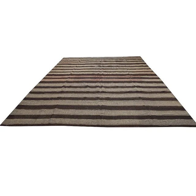 Oversized vintage brown handwoven kilim rug from Marash region of Turkey. Approximately 60-70 years old. In very good...