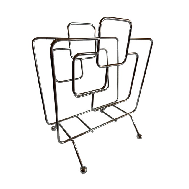 Super cool and very rare chrome magazine rack with four ball feet, mid-century modern to its finest