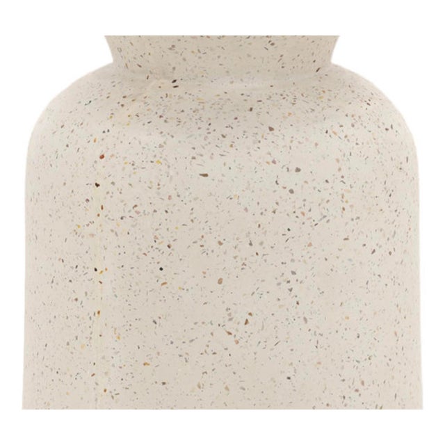 Concrete terrazzo round hourglass-inspired side table with white ground and speckles of browns, beiges, and grays. Perfect...