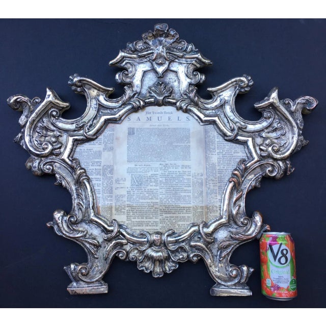 This original 18th century frame is silver gilded over copper. It is elaborately embossed and chiseled. The cartouche is...