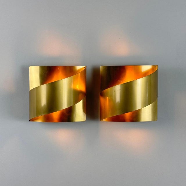 Discover the timeless elegance of mid-century Scandinavian design with this pair of polished brass wall lights, crafted in...