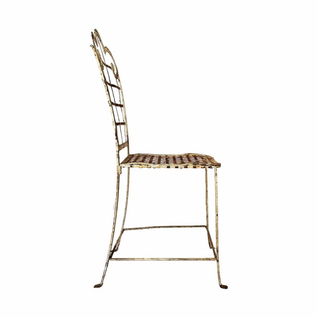 Antique wrought and cast iron garden chair with metal basket weave seat and backrest. Distressed painted finish....