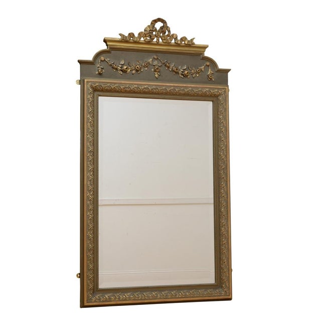 Attractive French wall mirror, having original bevelled edge glass in moulded and flower carved gilded frame with floral...