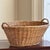 Offering a particularly stunning European-style laundry basket from the early- to mid-20th century. It features pretty...