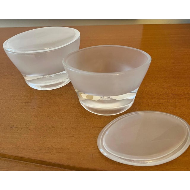 Pair of oval lidded frosted glass boxes. The pair are unique and very versatile, for use from the vanity to your work...
