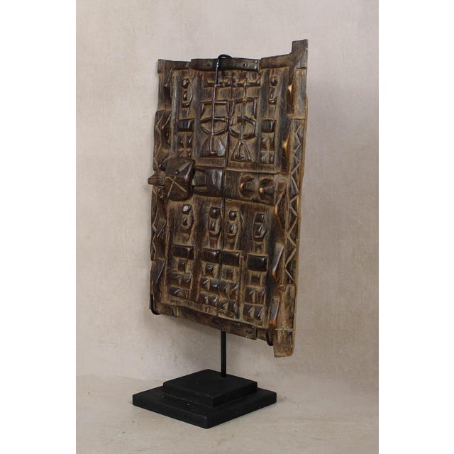 Dogon granary doors originate from the Dogon people of the Bandiagara Escarpment region of Mali. These doors protected the...