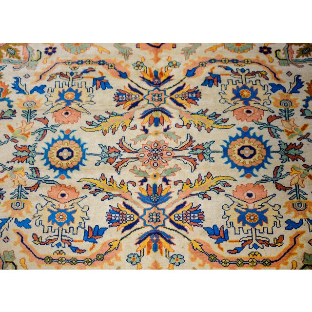 A breathtaking mid-20th century Persian Sultanabad rug with a large-scale mirrored floral patterned field woven in...