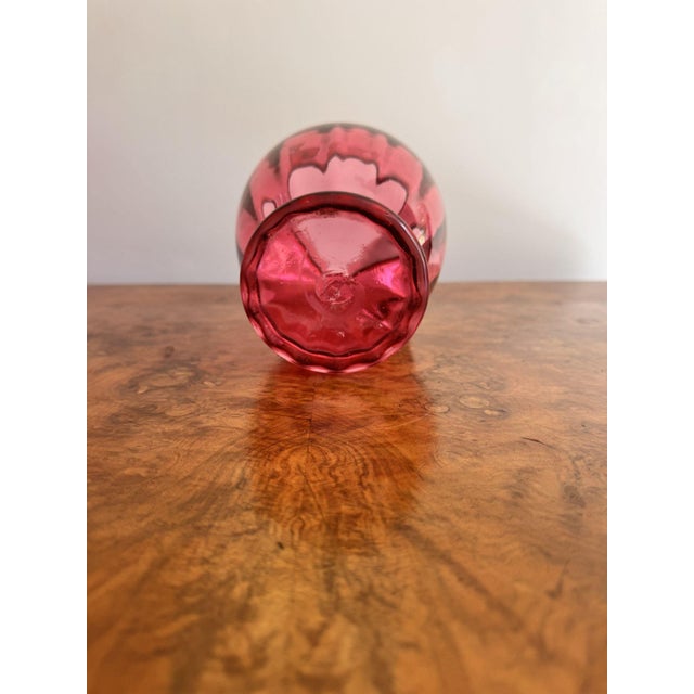 Pretty antique Victorian cranberry glass jug, having an original quality cranberry glass jug with a shaped handle to the...
