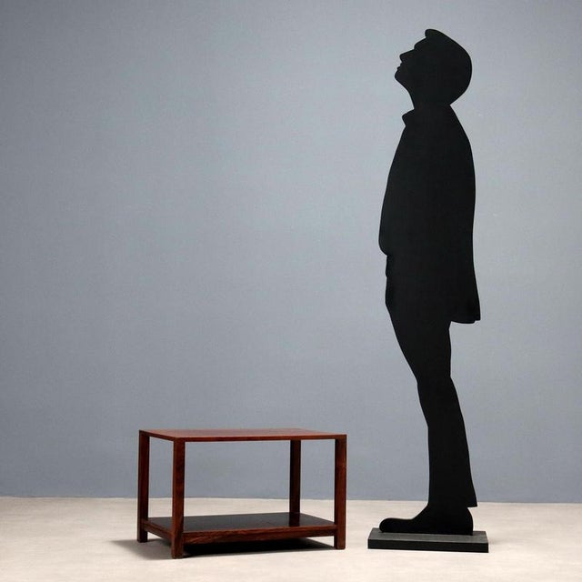 Double-tiered coffee table, exotic wood veneer. Good condition. This piece is attributed to the mentioned designer/maker....