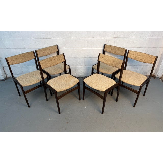 Elegant set of six mid-century modern Danish dining chairs Attributed to Erik Buch, Model 49. Crafted in richly grained...
