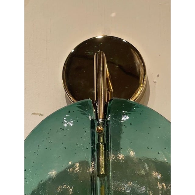 The Pair of Green Murano Lollipop Disc Sconces are elegant wall fixtures that wired and ready to go. These polished...