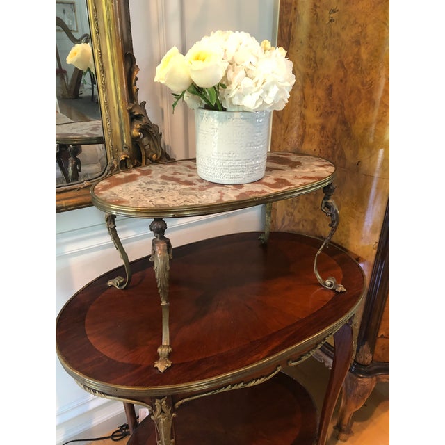 Lovely vintage French ormolu mounted mahogany tea accent table. Three- tier, marble top, cabriolet legs. Mahogany,...