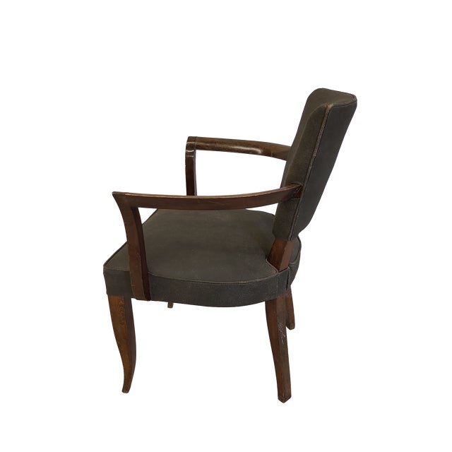 This art deco style side chair has beautiful walnut arms and legs and a distressed leather seat and back.