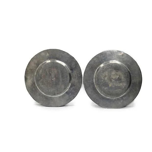 19th Century. French Pewter Chargers, Pair Pair of antique French pewter chargers. Pattern in center includes the head of...