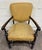 This is a vintage Spanish Revival or Renaissance Revival walnut armchair featuring graceful rolled arms, beautifully...