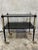 A sophisticated 1940s Regency-style ebonized drinks cart, richly detailed with bronze mounts, gilt accents, ribbed...