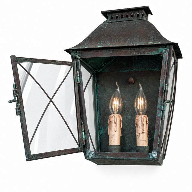A two-light exterior wall lantern by the federalist, model lewm-40b, crafted from coated heavy-gauge copper and finished...