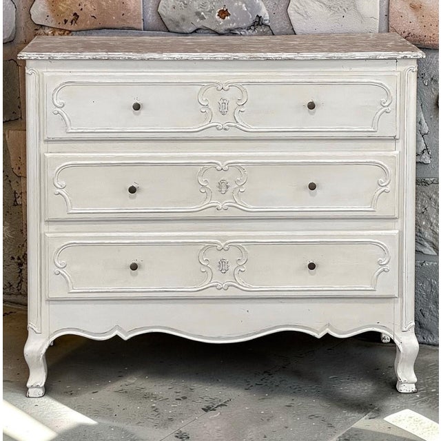 Country French character is beautifully expressed in this painted three drawer commode, shaped with the fluid lines and...