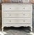Country French character is beautifully expressed in this painted three drawer commode, shaped with the fluid lines and...