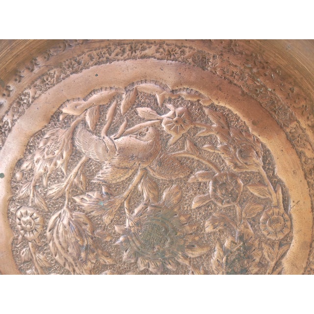 This striking vintage Persian copper wall charger features an intricate hand-worked bird and floral composition created in...