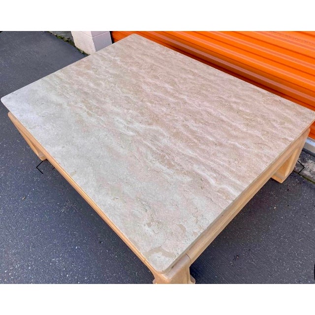 This wide Karl Springer influenced cocktail table has a chunky Ming Base and is a thick and substantial piece... a full...
