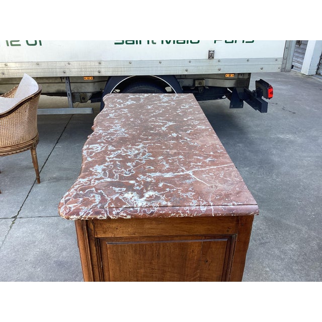 This is a true 18th century French Regency Commode. Made of warm French walnut, this piece features a serpentine front and...