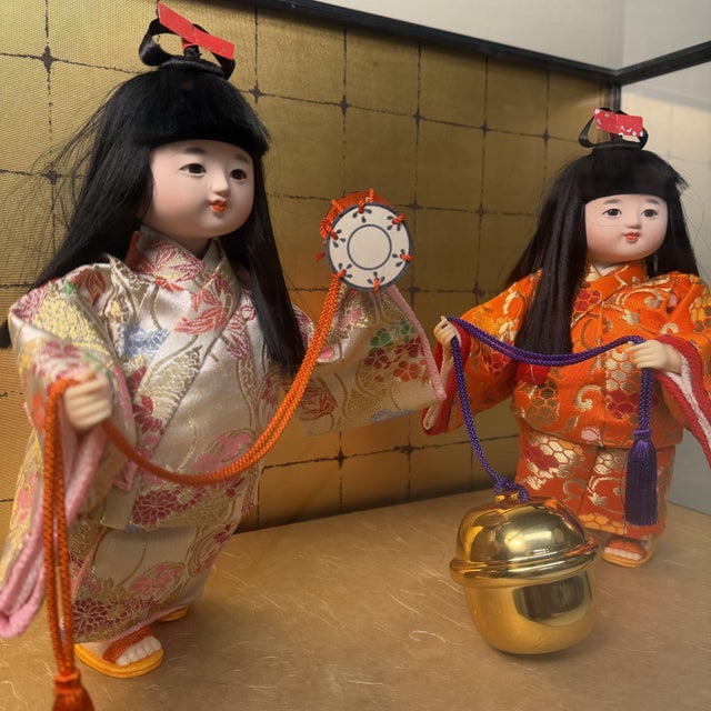 This complete Japanese seasonal display is presented in a wide glass showcase with a black lacquered wooden frame. The...