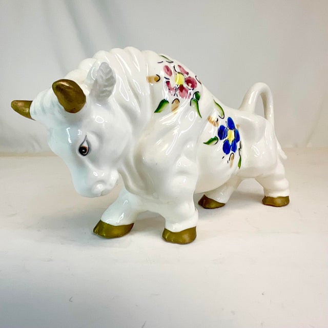 This is a stunning ceramic Bull figurine. It’s from Italy and features a muscular white bull with old gold tipped horns...