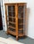 Design Plus Gallery presents an Antique Age Curio Cabinet. The curio has a central glass paneled door with two curved...