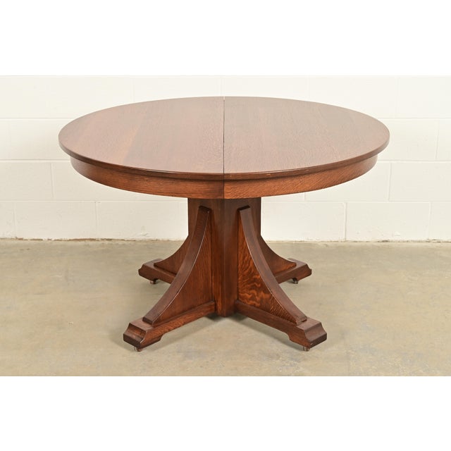 An exceptional antique Mission or Arts & Crafts period quarter sawn oak pedestal extension dining table By Stickley...