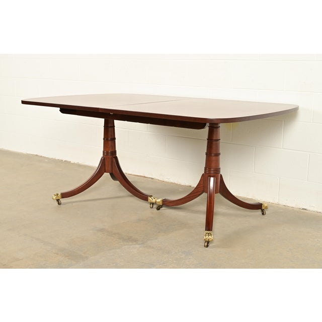 An exceptional Georgian or Regency style double pedestal dining table By Kittinger USA, Circa 1980s Gorgeous book-matched...