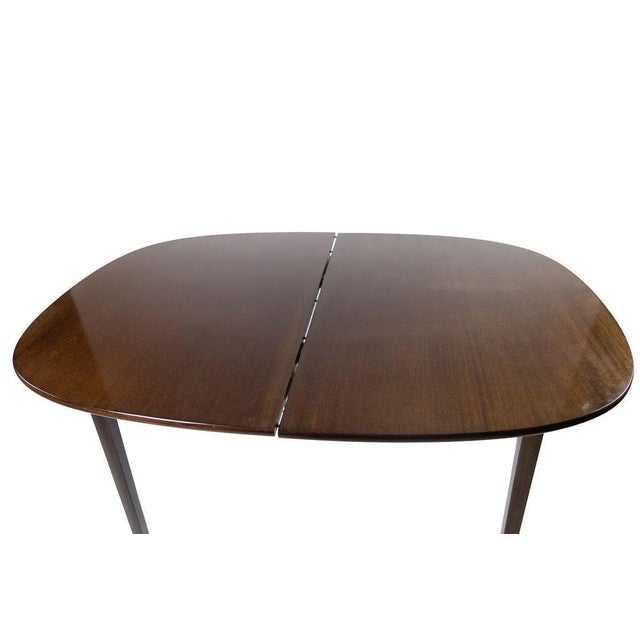 Rungstedlund dining table in mahogany designed by Ole Wanscher and manufactured by P. Jeppesen in the 1960s. The table is...