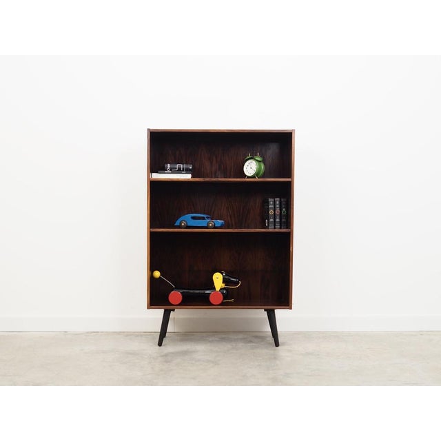 The bookcase was made in the 1970s, Danish production. The structure is covered with mahogany veneer. The legs are made of...
