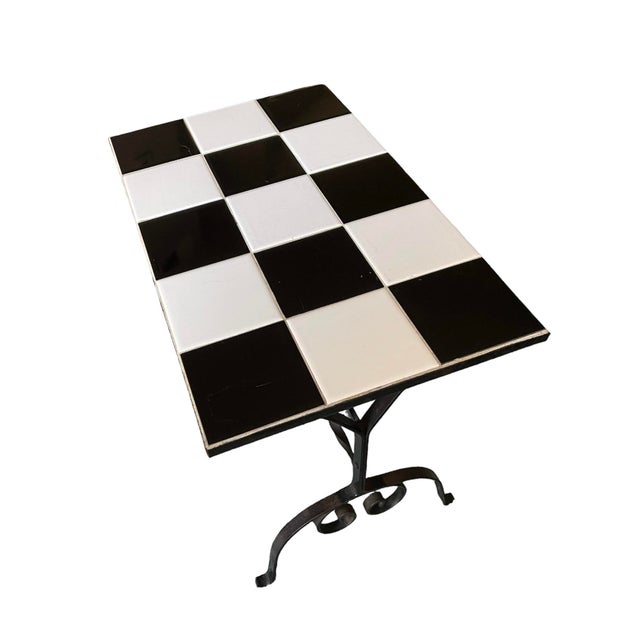 A Mid-Century Modern rectangular black and white ceramic mosaic tile end, side, or drinks table, circa mid-20th century....