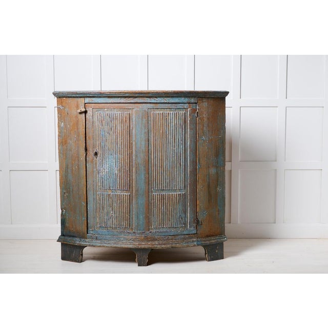Folk art blue cabinet from the early 1800s. This antique corner cabinet is made in gustavian style in northern Sweden...