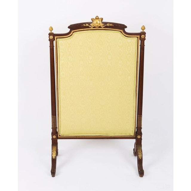 An elegant antique french louis xvi ormolu mounted mahogany fire-screen, circa 1870 in date. This fine mahogany screen has...