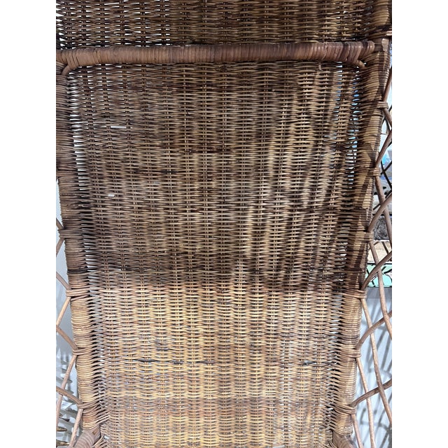 This striking pair of vintage hooded wicker chairs are chic and sculptural. Featuring dramatic arched canopies, woven...
