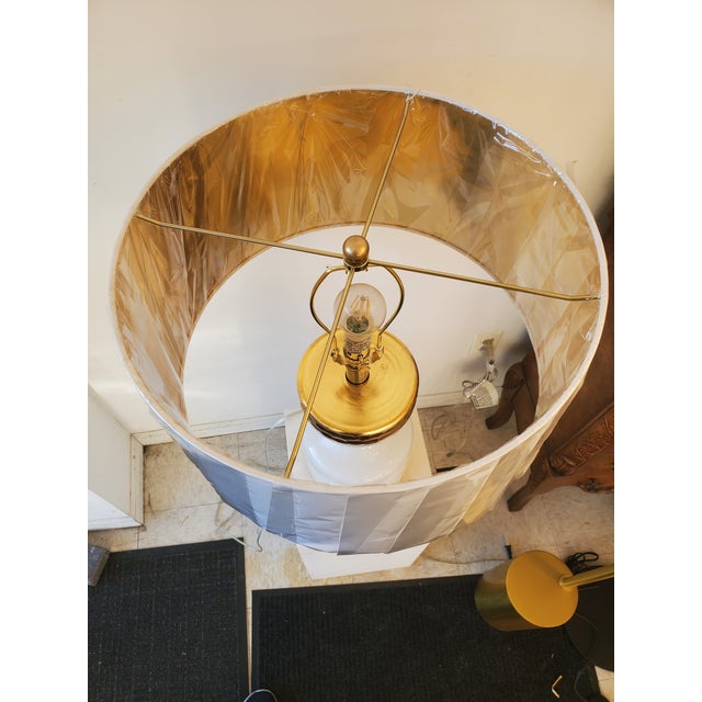 This Beautiful milk white and gold table lamp featuring a white modern shade win gold inside. This lamp is suitable for a...
