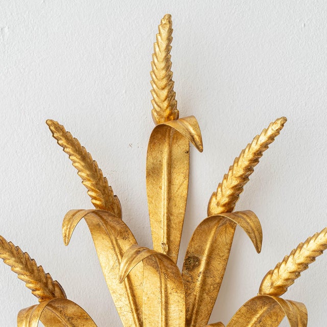 Pair of Italian gilt brass wheat sheaf wall sconces in the Hollywood Regency style. This pair is a later production made...