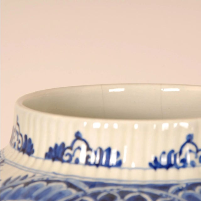 A pair Dutch Delftware Royal Delft vases - Urns. Tall decorative covered baluster vases on an octagonal foot. The vases...