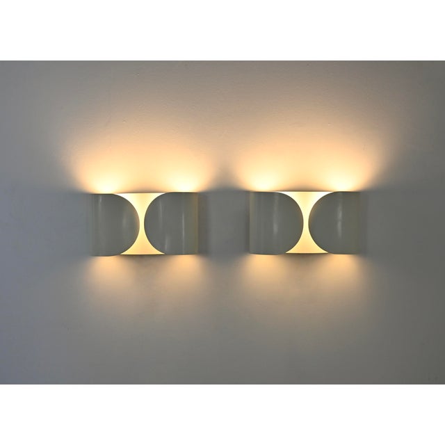 Pair of white metal wall lights by Afra & Tobia Scarpa. Model: Foglio. Wear consistent with age and time. This piece has...