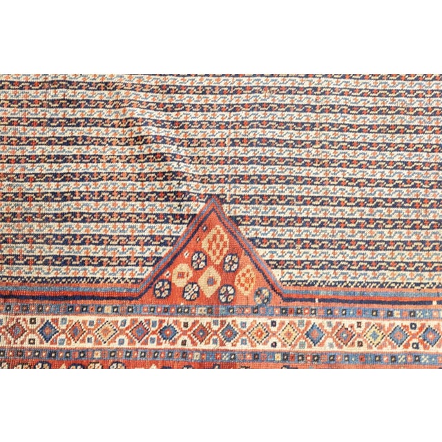 Characteristic Khamseh bitonal cane stripe field pattern and red triangular flower-filled corners. Soft red main border...